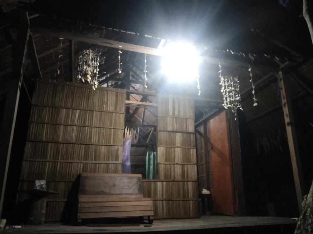 a light on top of a wooden building with a barrel at Aldy homestay in Yennanas Besir