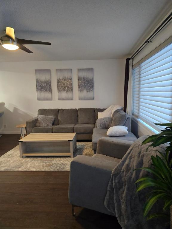 a living room with a couch and a coffee table at Full House - Main Floor in Regina