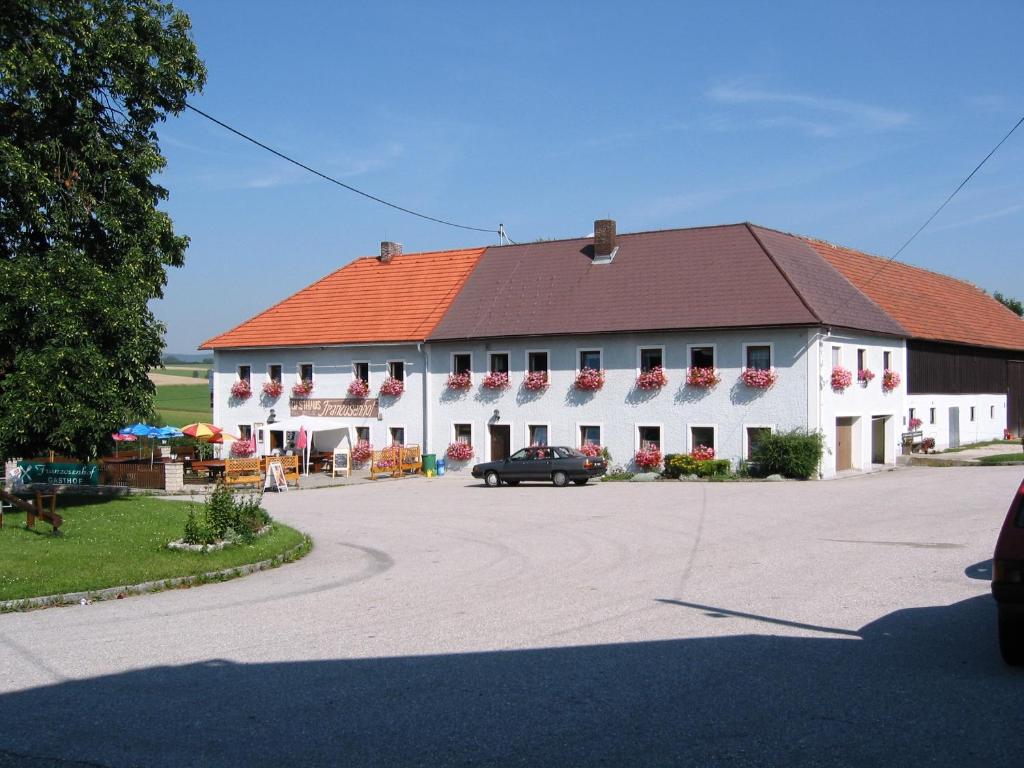 un gran edificio blanco con techo rojo en Gasthof Franzosenhof, en Wullowitz