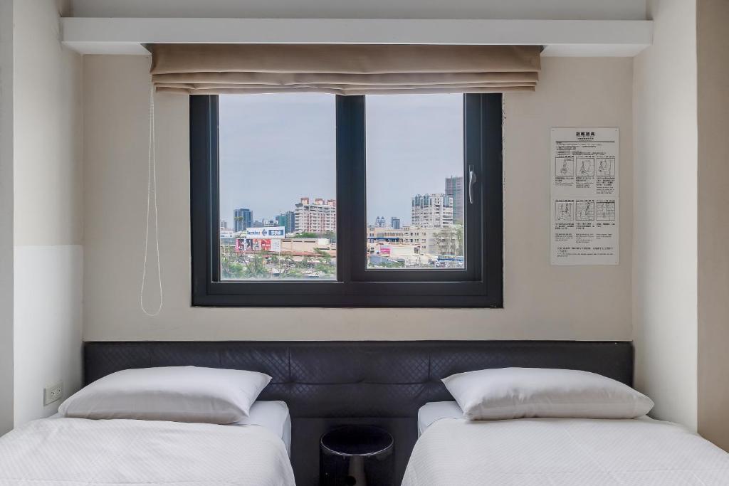 Postel nebo postele na pokoji v ubytování CHECK inn Express Kaohsiung Love River