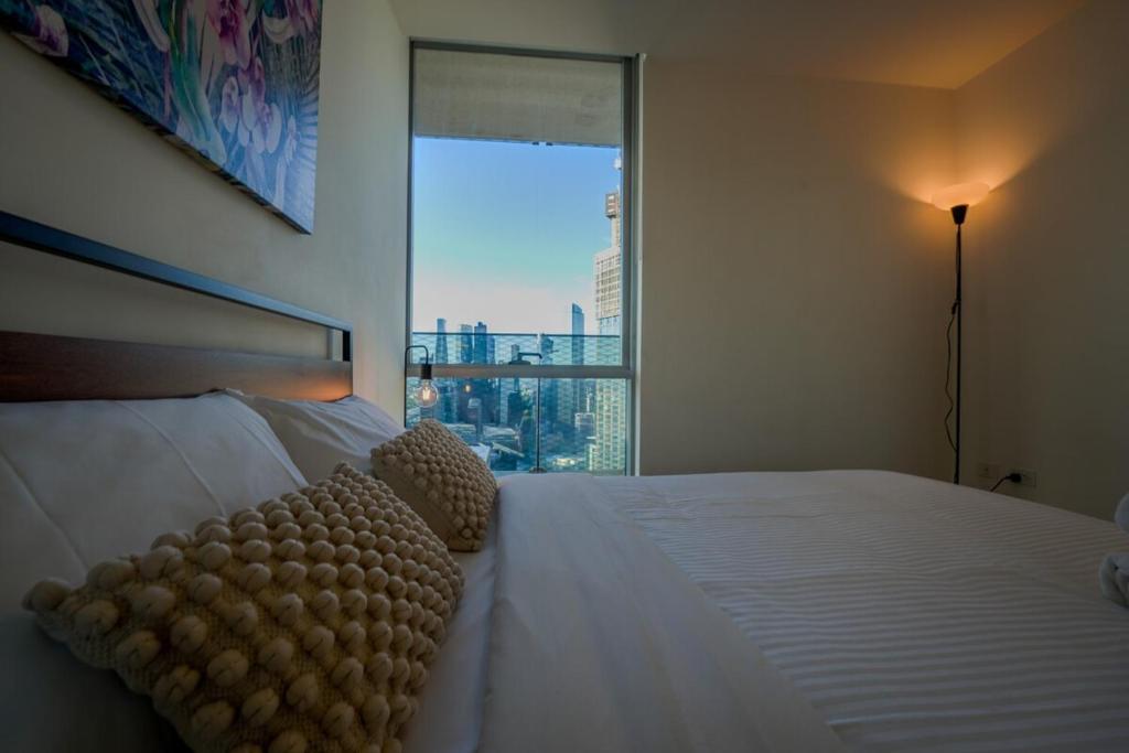a bedroom with a bed with a view of a city at Southbank 40 in Melbourne