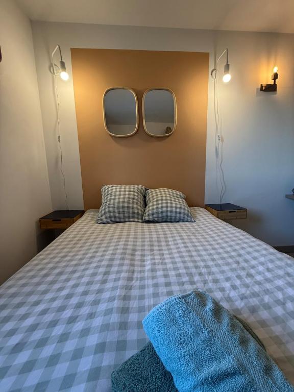 - une chambre avec un lit et deux miroirs sur le mur dans l'établissement Studio 108 Parking Gratuit, à Aix-en-Provence