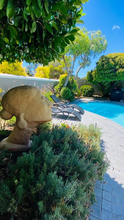 a large mushroom statue sitting next to a swimming pool at Bicycle Lodge Apartment in Tokai