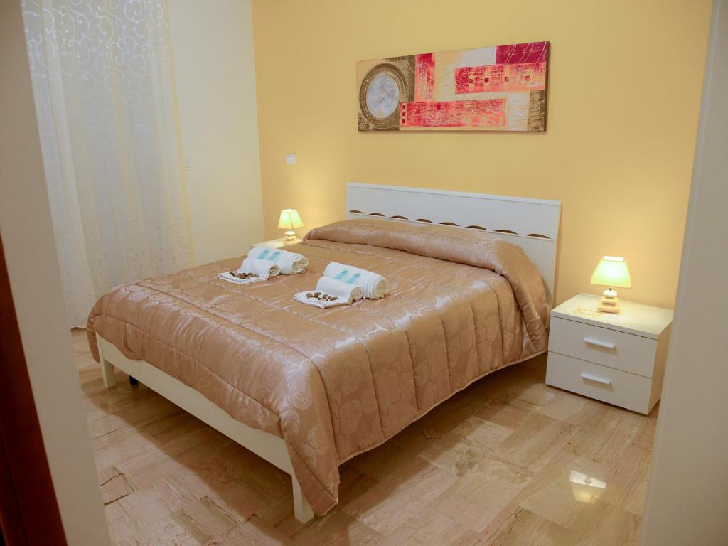 a bedroom with a bed with two pillows on it at Case Saniela in Terrasini