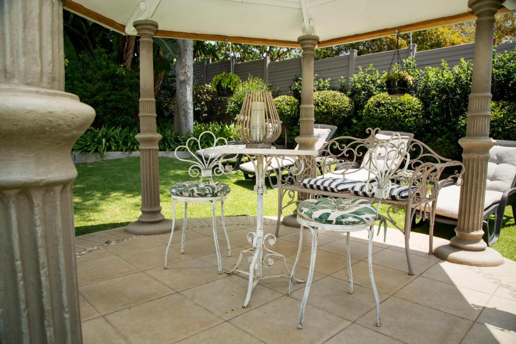 a group of chairs and a table on a patio at La Vida Luka - Luxury Guesthouse in Pretoria