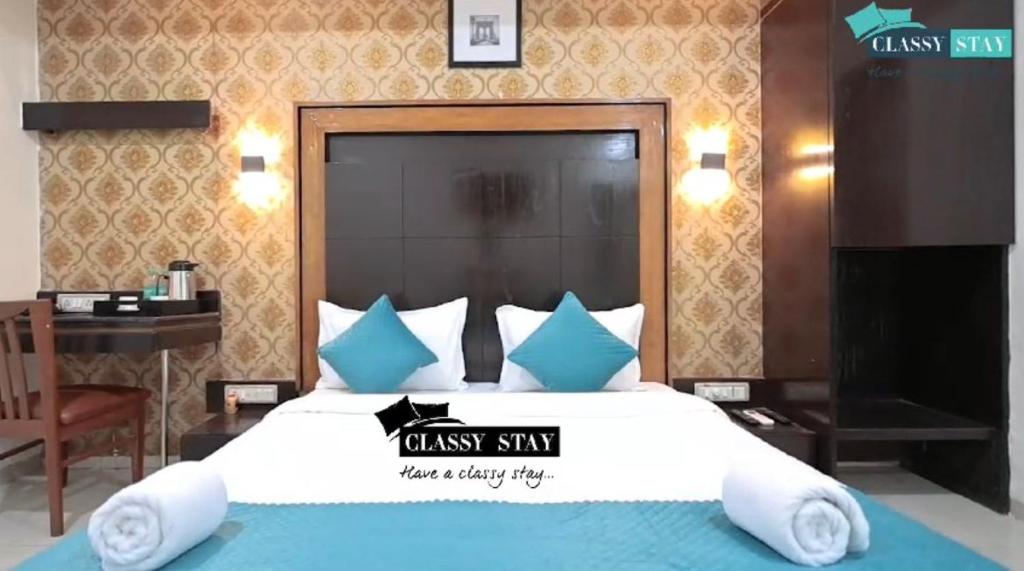 a bedroom with a large bed and a desk at Manas Residency Classy Stay in Mumbai