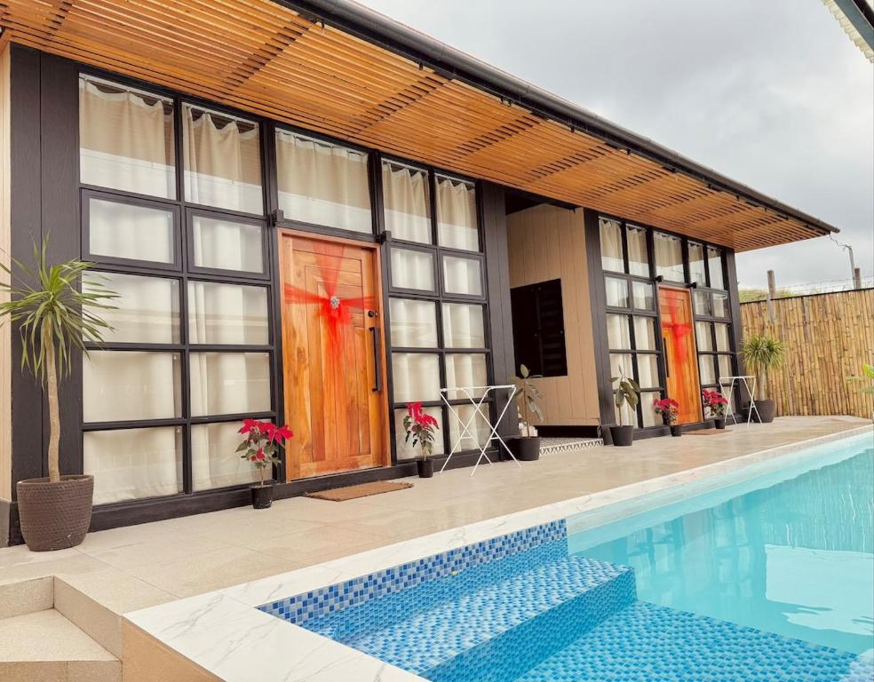 a house with a swimming pool in front of it at Casa nel Mezzo - A Pineapple Farm Escapee in Ulot