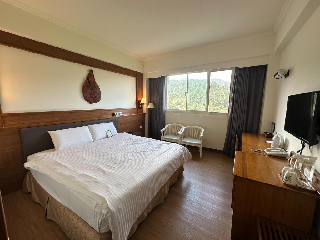 Postel nebo postele na pokoji v ubytování Ginkgo Hotel