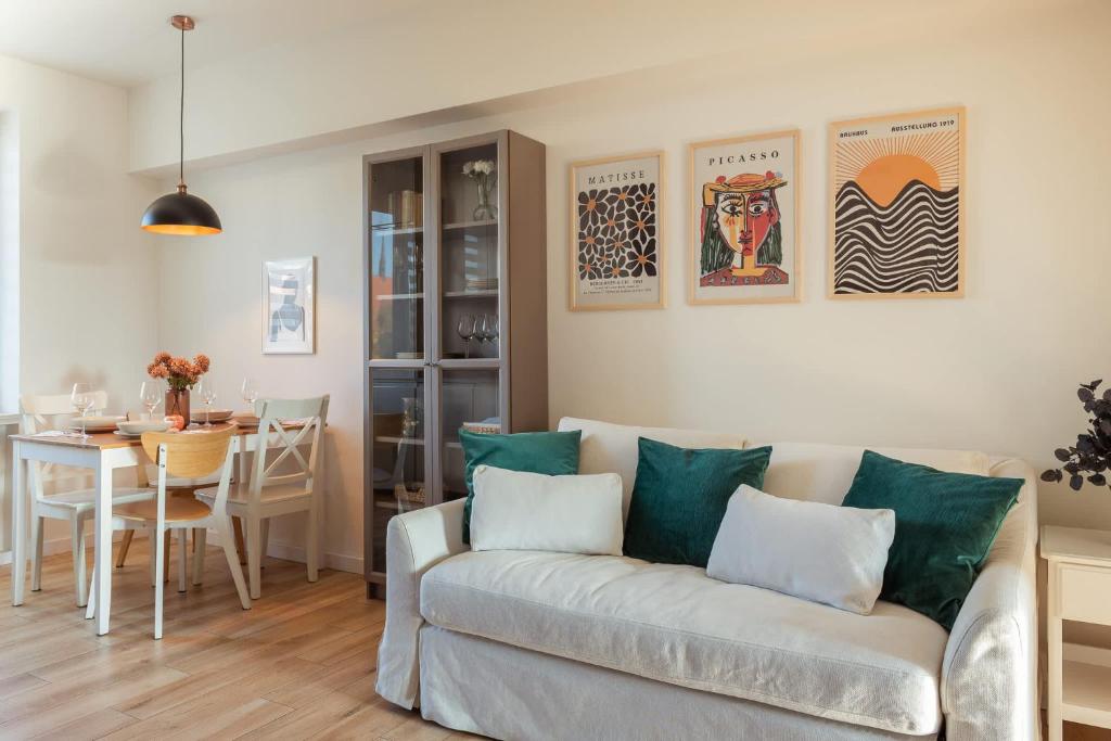 a living room with a couch and a table at Cozy Apartment with Balcony near Old Town Gdańsk by Rent like home in Gdańsk
