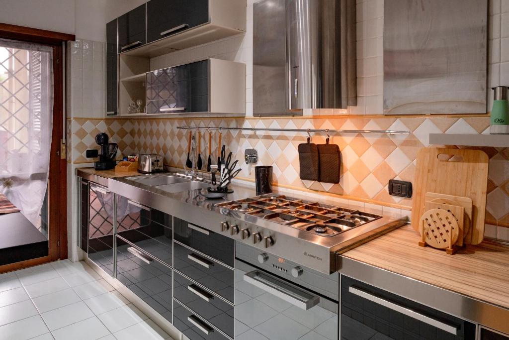 a kitchen with a stove and a sink at Fiera & Airport-Suite Leonardo Relax- Garden & wi-fi free in Fiumicino Airport