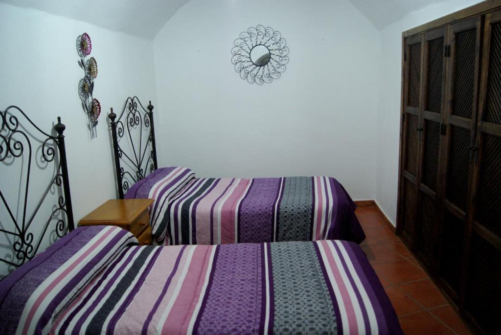 Postel nebo postele na pokoji v ubytování Cuevas de María