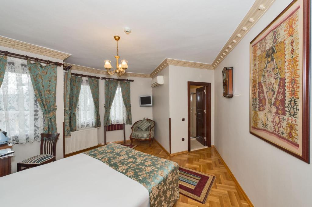 Postel nebo postele na pokoji v ubytování Osmanhan Hotel