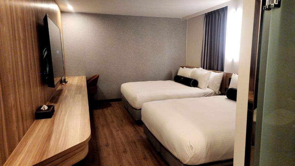 Postel nebo postele na pokoji v ubytování Jiati Business Motel
