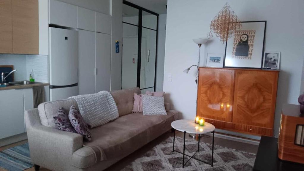 a living room with a couch and a table at Stylish city center home with sauna in Rovaniemi