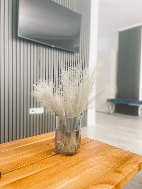 a vase with feathers in it sitting on a table at Noa Residence in Alba Iulia