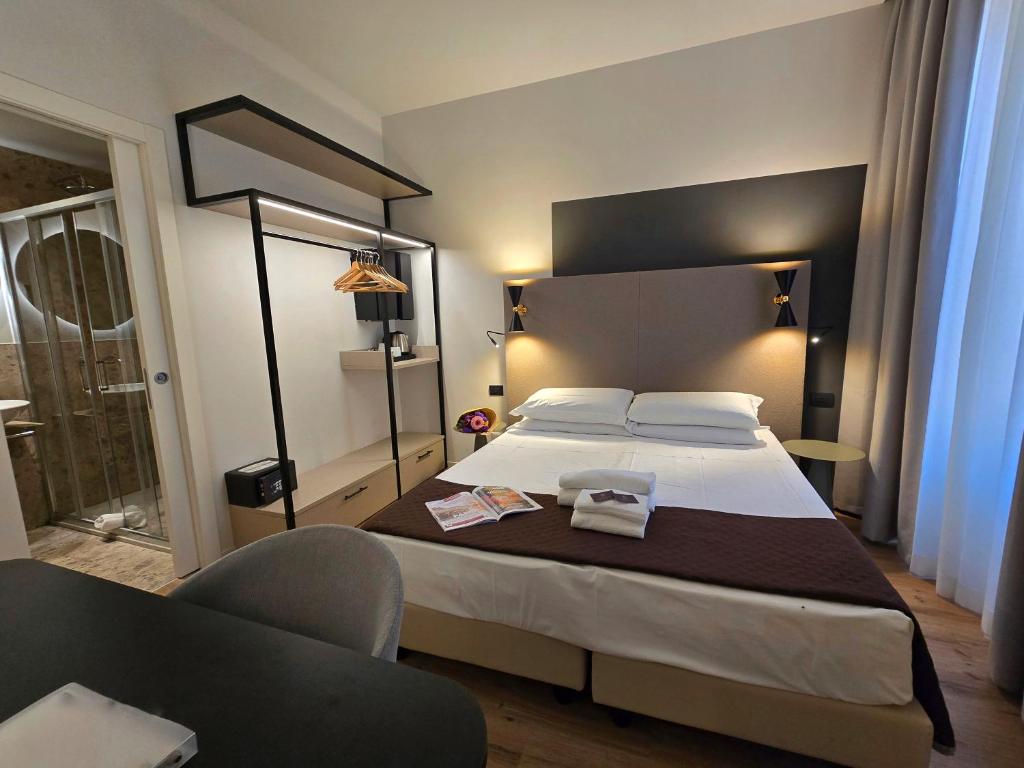 Postel nebo postele na pokoji v ubytování Hotel Porta Pia