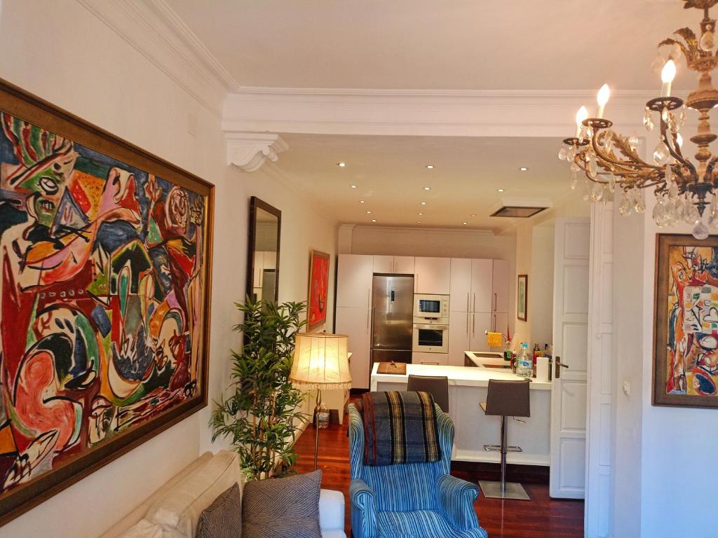 un soggiorno con un grande dipinto sul muro di Small stylish room with comfortable queen-size bed in very large, beautifully decorated shared flat in the historic centre of Malaga a Málaga