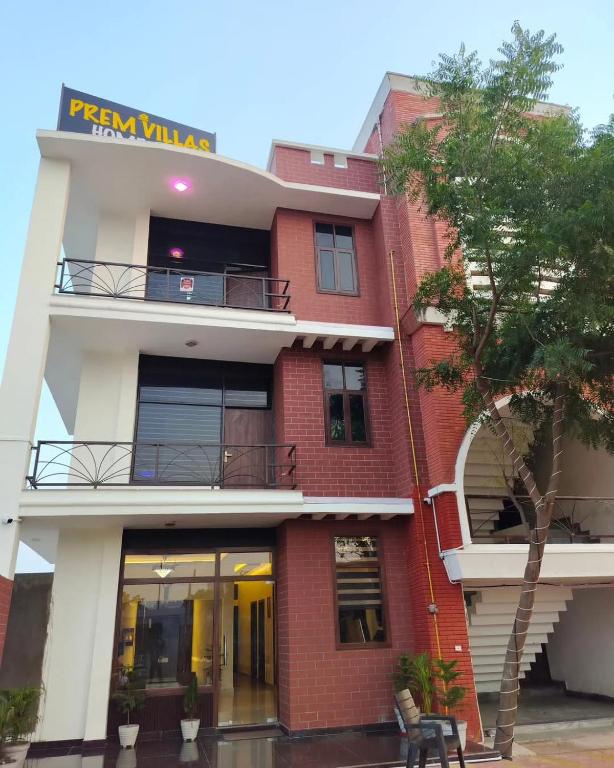 a red brick building with a sign on it at Prem villas homestay in Tājganj