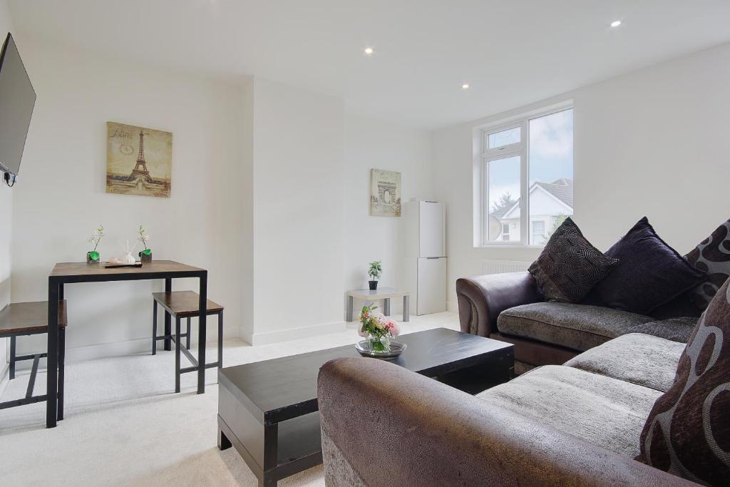 a living room with a couch and a table at Columbia Road in Bournemouth