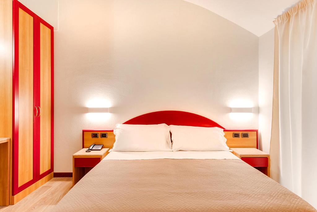 Postel nebo postele na pokoji v ubytování Custodisca Hotel Evolution