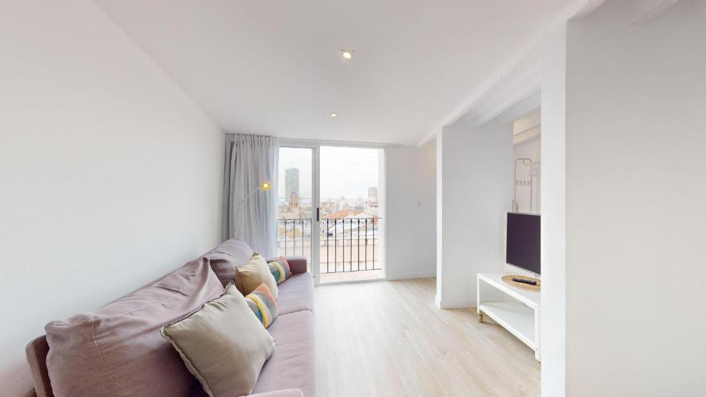 a living room with a couch and a television at Myflats Old Corner in Alicante