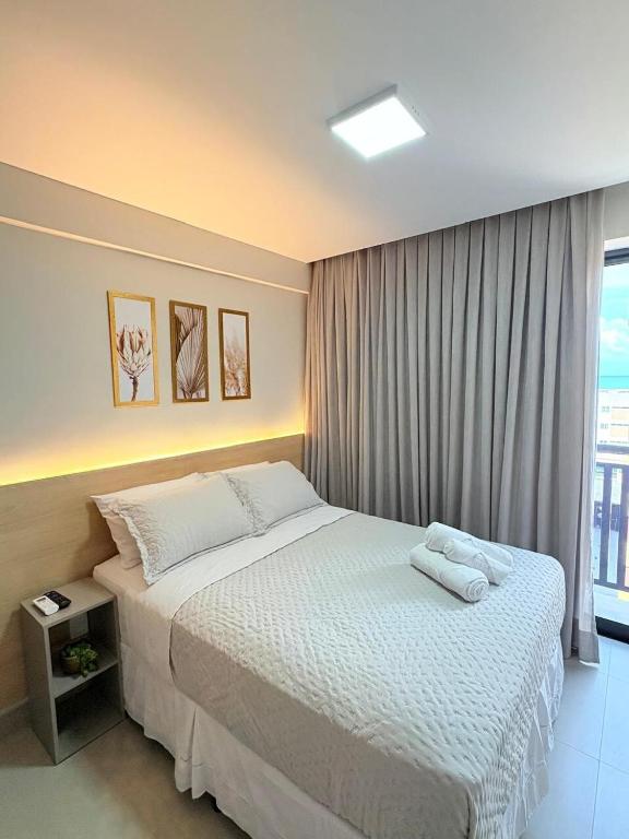a bedroom with a large bed and a window at Paradise at your fingertips in Cabedelo