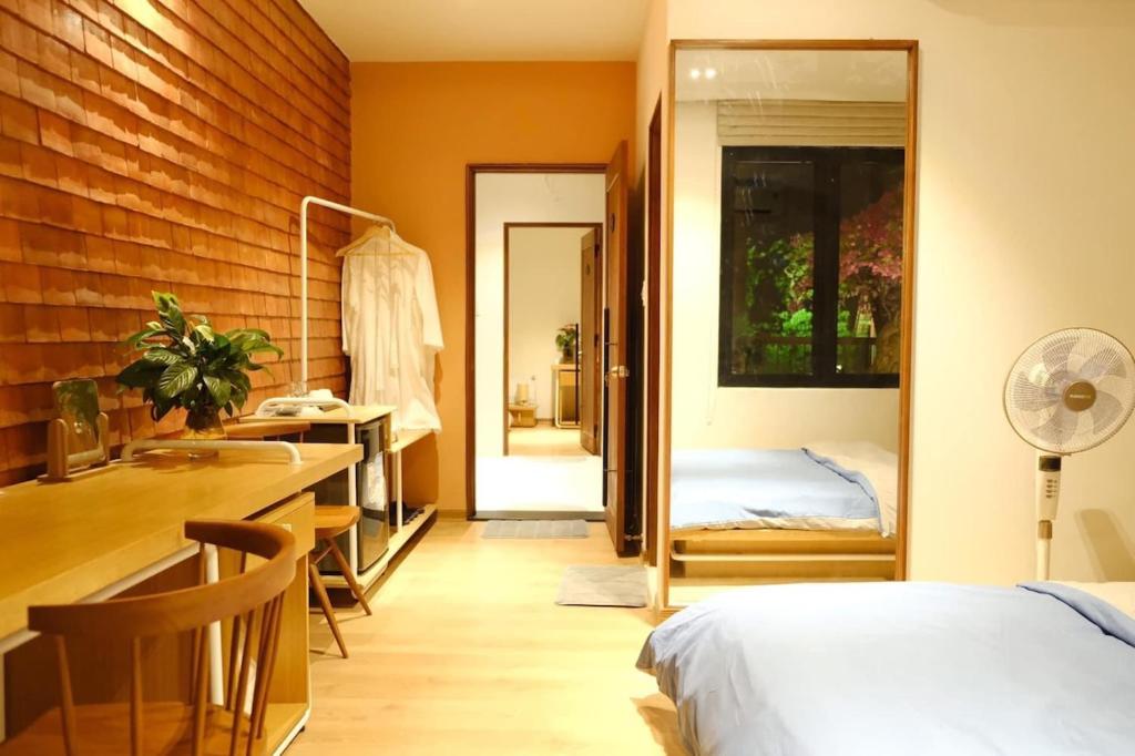 a bedroom with a bed and a desk and a sink at Florence Villa Hue in Hue