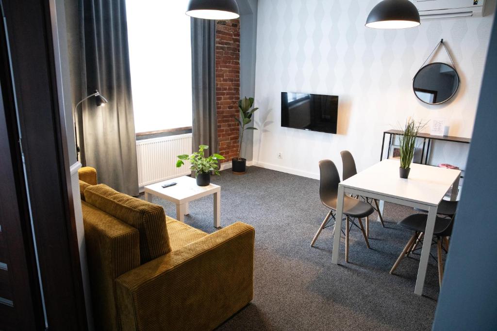a living room with a couch and a table at New Adler Bed & Breakfast in Łódź