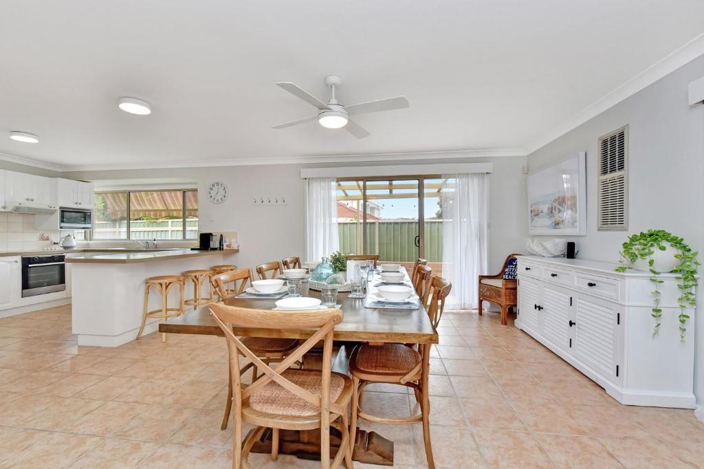 a kitchen and dining room with a table and chairs at The Fingal Escape in Fingal Bay
