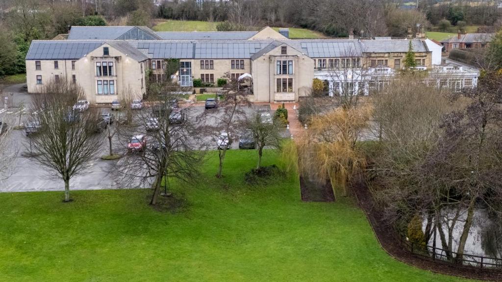 an aerial view of a large house with a green yard at Gomersal Park Hotel &amp; Bazaar Spa in Cleckheaton