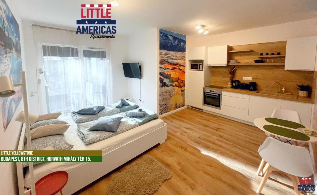 a small bedroom with a bed and a kitchen at Little Americas National Parks Apartments in Budapest