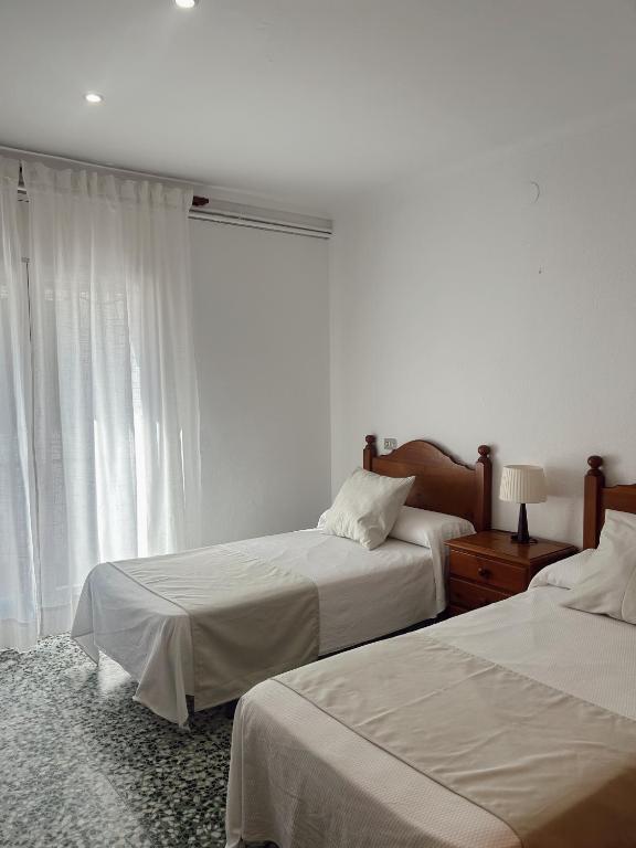 Postel nebo postele na pokoji v ubytování Hostal La Tina