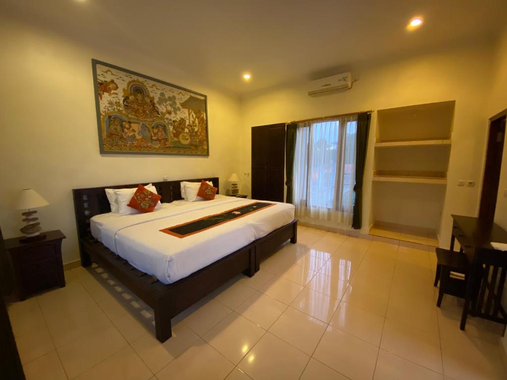 Postel nebo postele na pokoji v ubytování Brata Inn Ubud