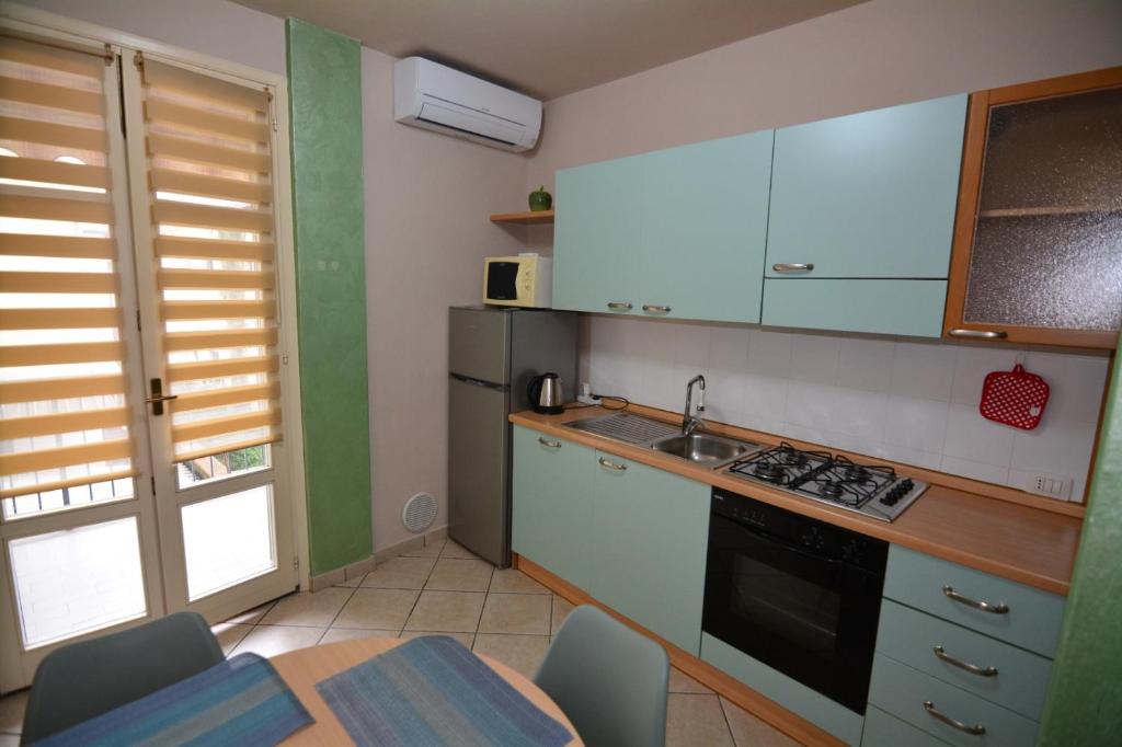 a kitchen with a sink and a stove top oven at Diana's home in Empoli