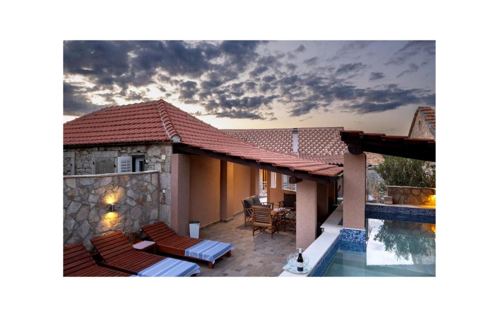 a house with a patio and a swimming pool at Awesome Home In Zastrazisce With Wifi in Zastražišće