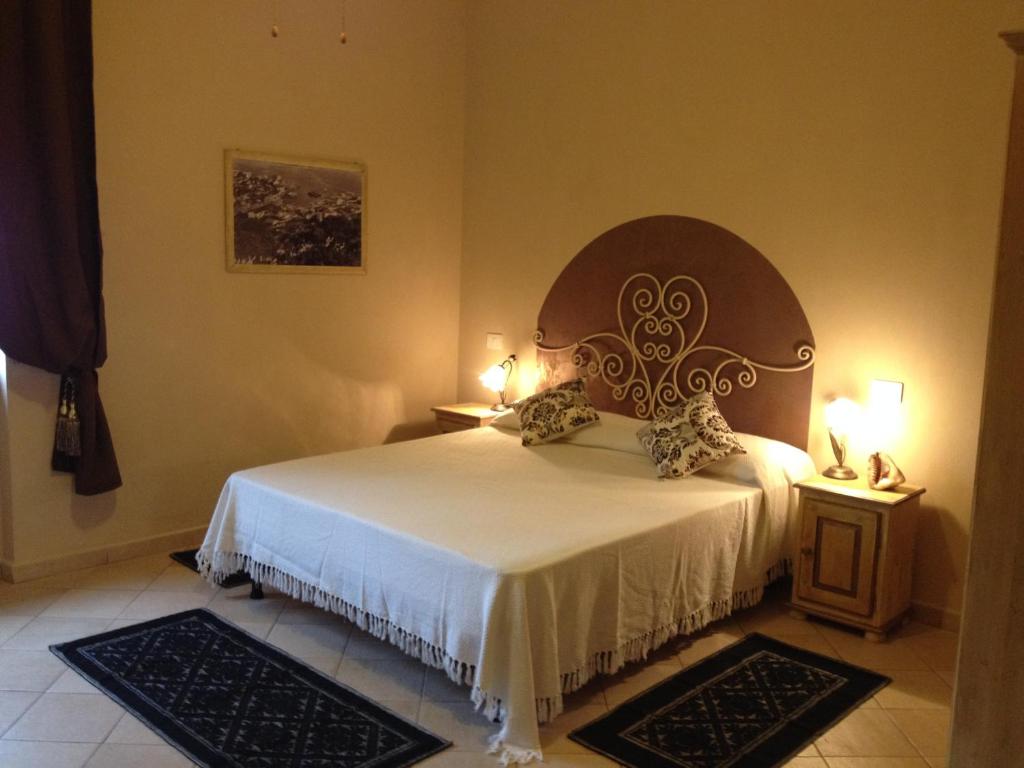 a bedroom with a bed and two night stands at Stella di Mare in La Maddalena