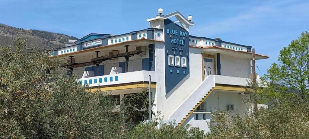 a building with a sign on the side of it at Blue Bay Beach Hotel in Koinyra