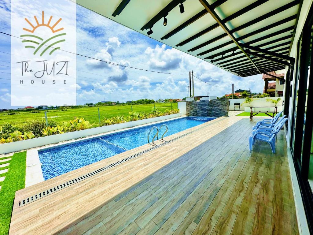 a house with a swimming pool and a patio at The Juzi House - private pool homestay in Kuala Terengganu