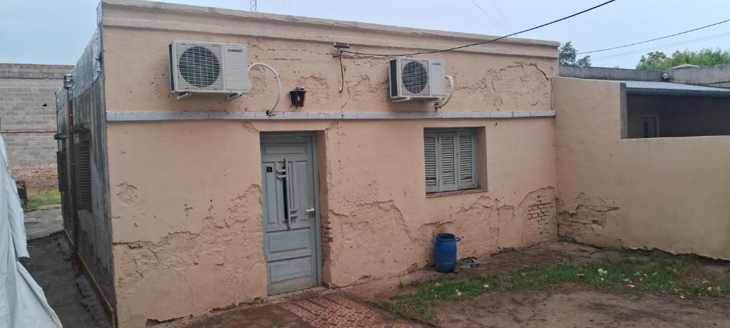 una vista exterior de una casa con 2 aparatos de aire acondicionado en Excelente Ubicación con Cochera Privada, en Ciudad Evita