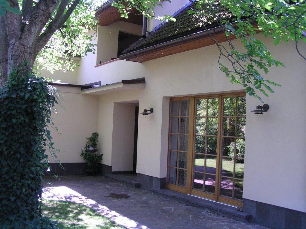 a white house with a large glass door at Apartment 53 Zvíkovské Podhradí in Zvíkovské Podhradí