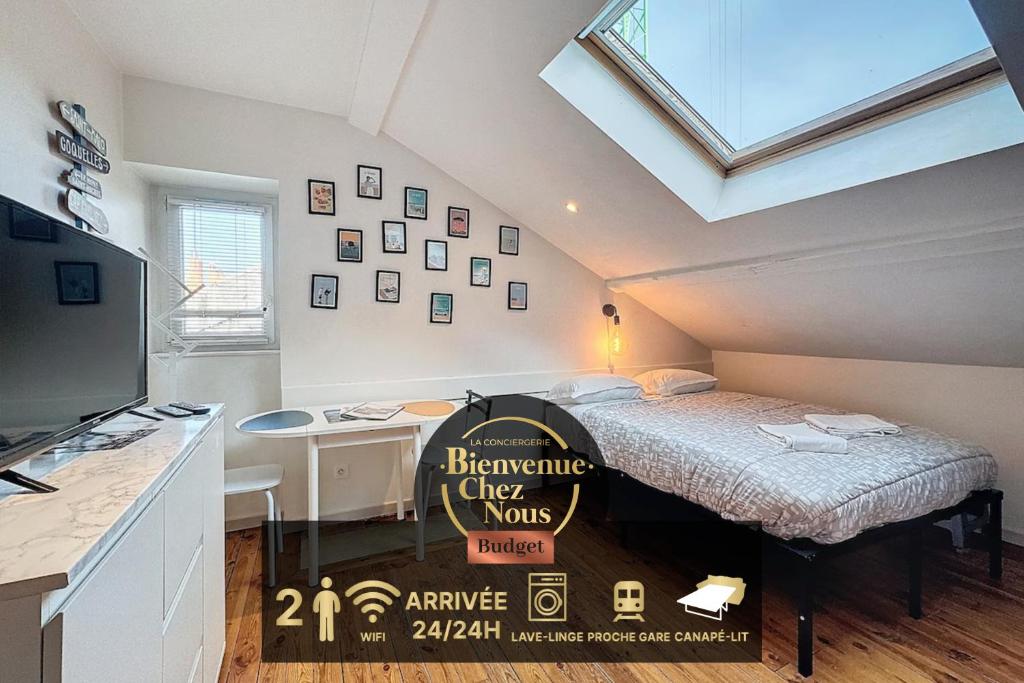 Cette chambre mansardée comprend un lit et un bureau. dans l'établissement Studio Avenue de la République - A, à Clermont-Ferrand