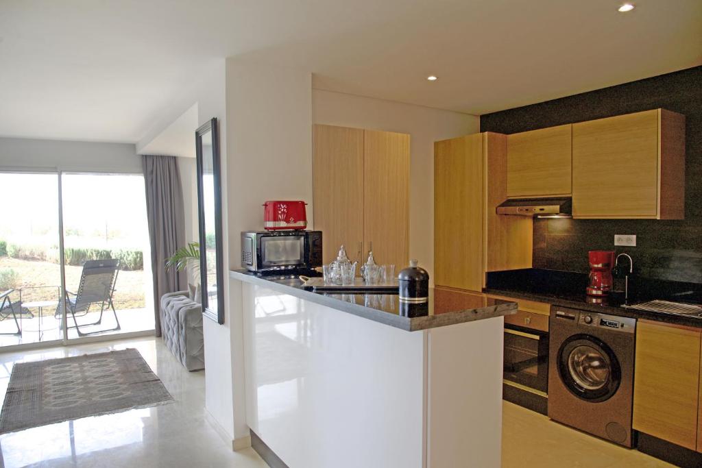 Kuchyň nebo kuchyňský kout v ubytování Appartement luxe vue Mer & Golf -Taghazout Bay
