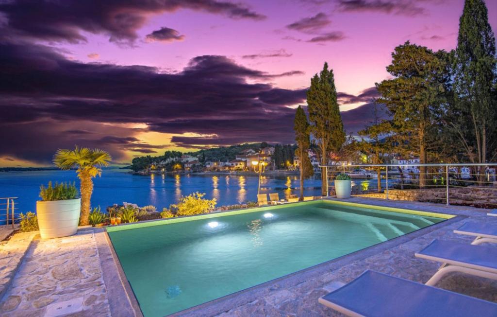 a swimming pool with a view of the water at Beautiful Villa Zman near sea in Dugi Otok in Žman