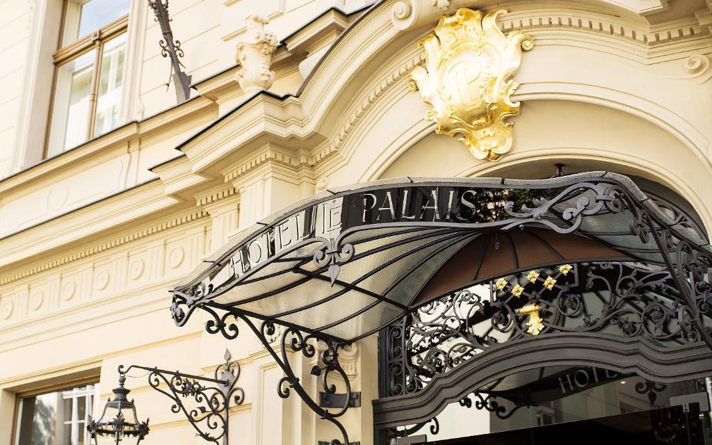 a sign on a building that says raffles at Le Palais Art Hotel Prague in Prague