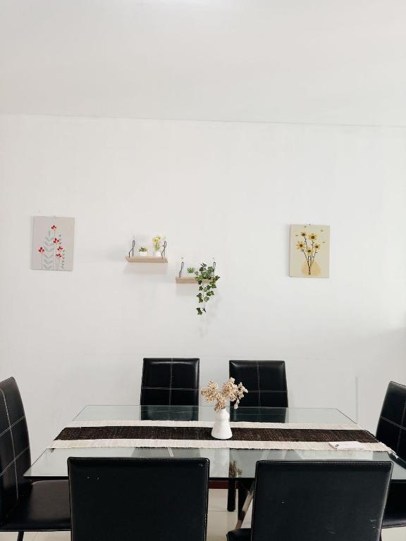 a dining room with a table and four chairs at Premium Getaway in City Central in Jakarta
