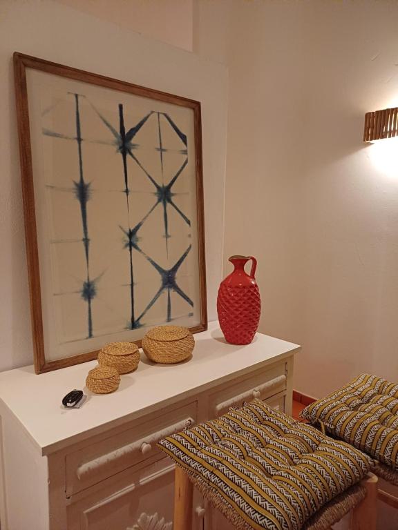 a table with a mirror and a vase on it at Comporta House in Comporta