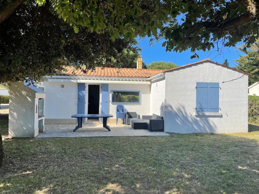 - une table de pique-nique devant une maison blanche dans l'établissement Maison bord de mer, à Saint-Pierre-dʼOléron