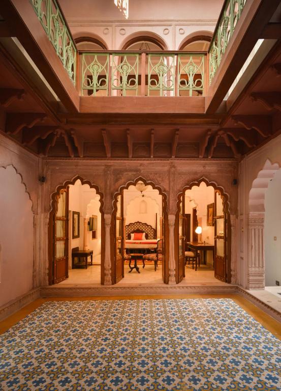 Postel nebo postele na pokoji v ubytování Haveli Dharampura & Golden Haveli- UNESCO awarded Boutique Heritage Hotel