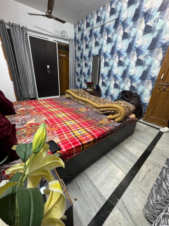 a bedroom with a bed with a snake on it at Double room with balcony in Prayagraj