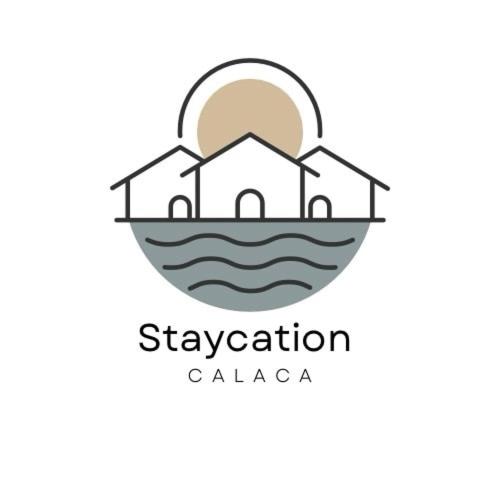 a logo of a house on the ocean with the setting sun at Staycation Calaca in Calaca